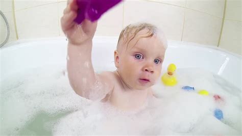 cute one year old girl taking a relaxing bath with foam stock footage video 14125394 shutterstock