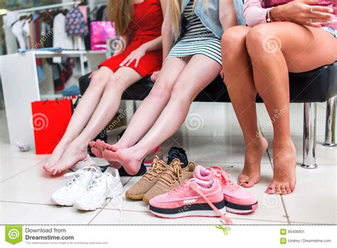 Close Up View Of Barefoot Long Slim Female Legs Surrounded By Variety