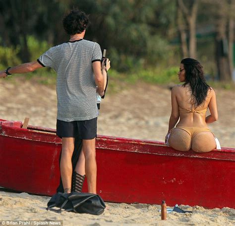 kim kardashian reveals inflated beach bum in tiny bikini on shoot daily mail online