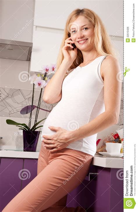 pregnant blonde on the phone royalty free stock image
