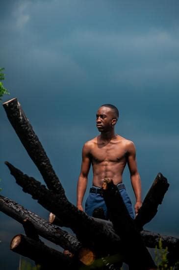 A Topless Man Standing Beside The Wall Photos By Canva