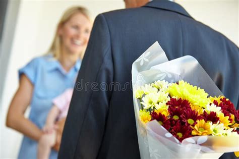 surprising her on her birthday a man surprising his wife with flowers