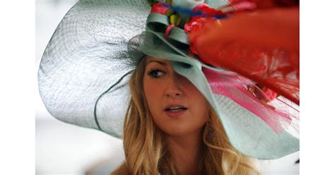 a floppy hat with all the bells and whistles adorned this woman in why do women wear hats at