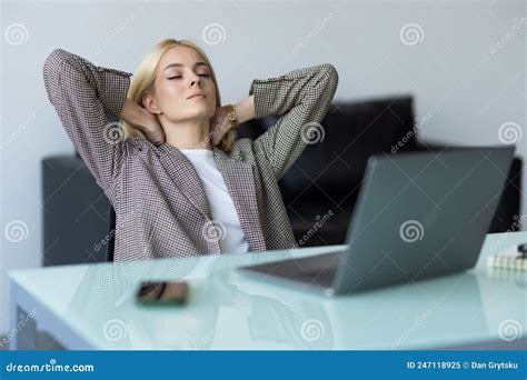 Business Young Woman Relaxing With Her Hands Behind Her Head And