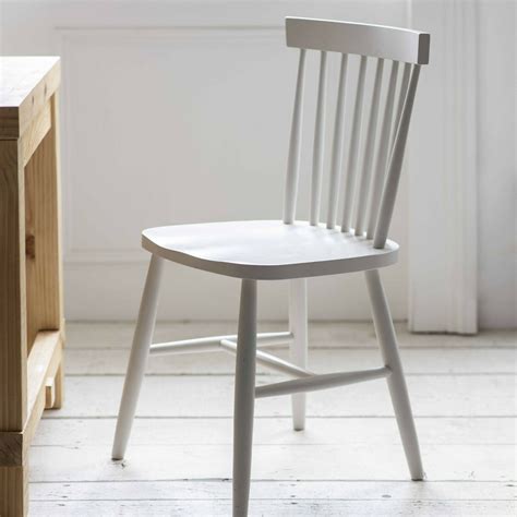 white spindle  dining chair  blue door