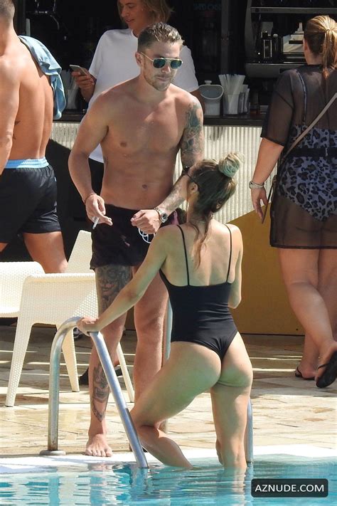 chloe sims talks to a tattooed sam mucklow by the pool at