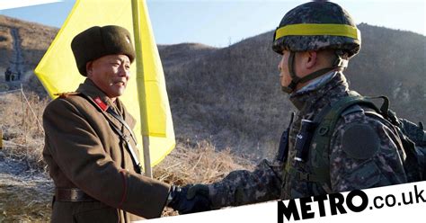 historic moment soldiers from north and south korea shake