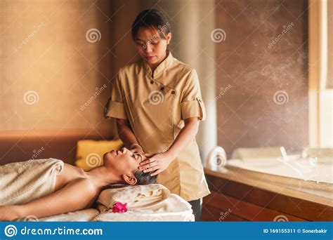 beautiful woman having thai massage relaxation concept at spa stock