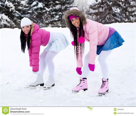 two girls ice skating stock images image 12032264