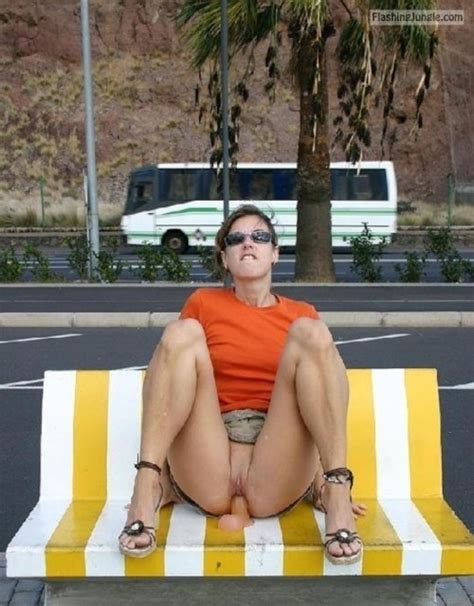 bitch in orange t shirt sitting on dildo next to public