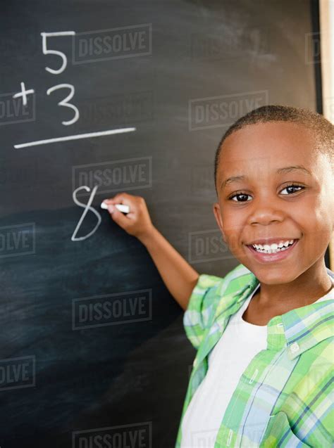 black boy solving math problems  blackboard stock photo dissolve