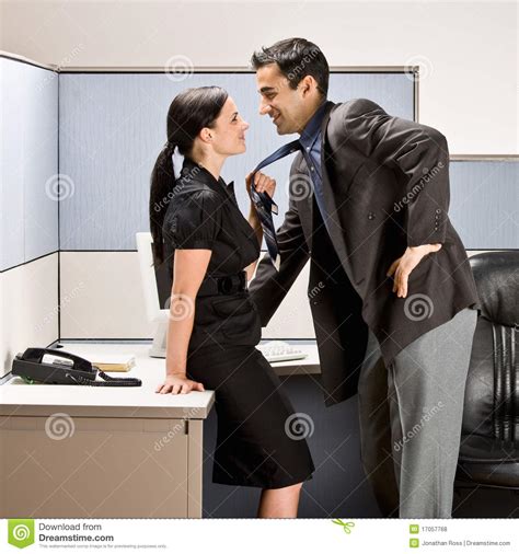 Co Workers Kissing In Office Cubicle Royalty Free Stock