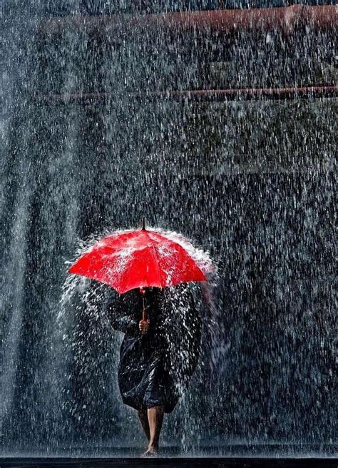 woman holding  red umbrella walking   rain walking   rain