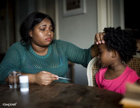 African Mother Taking Care Of Her Sick Daughter Premium Image By