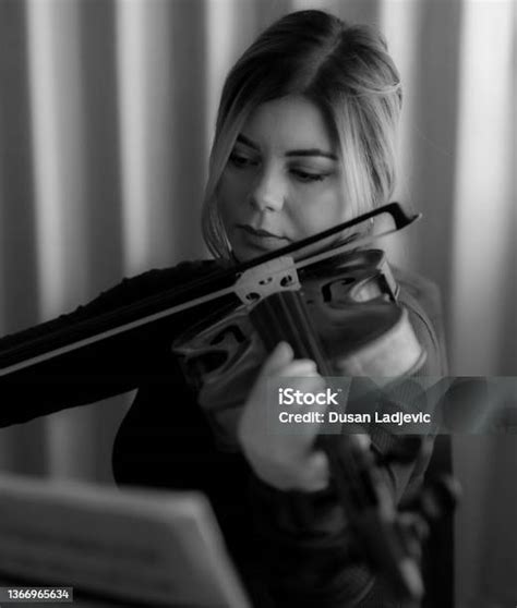 black and white pictures of a beautiful girl playing viola and