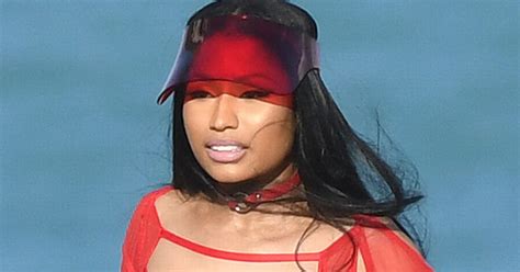 nicki minaj flaunts unreal curves in red cutout swimsuit as she films