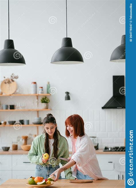 Two Girlfriends Cut Fruit In The Kitchen Stock Image Image Of Fruit