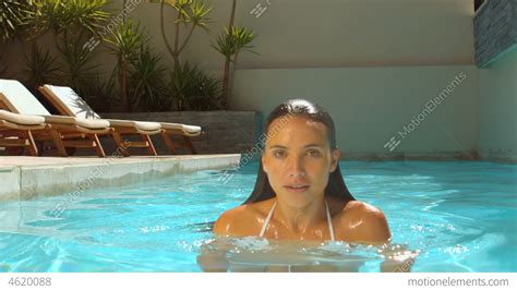 woman emerging from swimming pool stock video footage 4620088