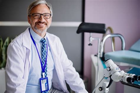 portrait of a mature adult male gynecologist in the examination room