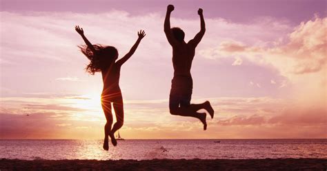 excited happy cheering people jumping  beach  sunset summer travel