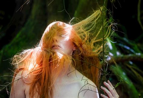 Sensual Portrait Of Beautiful Redheaded Woman Shakes Her Hair Outdoors