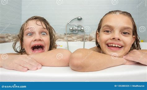 two sisters bathe in the bath and make fun faces stock image image of