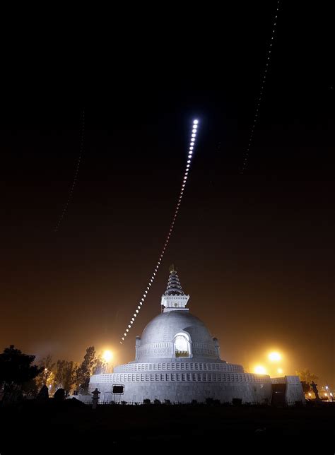 apod 2011 december 14 a lunar eclipse over an indian peace pagoda