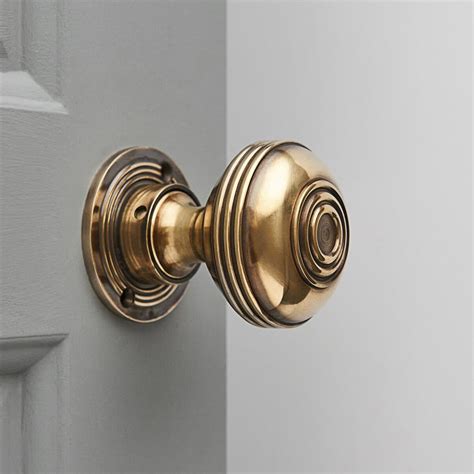 large bloxwich regency style door knobs  aged brass
