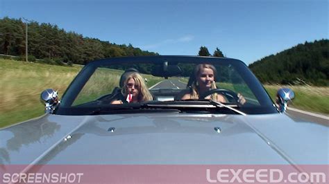 2 girls driving revving bmw z8 on a hot summer day