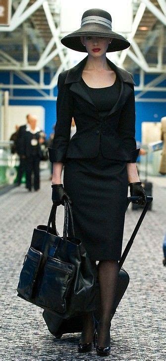 Sleek Black Skirt Suit Paired With Tights A Chic Hat