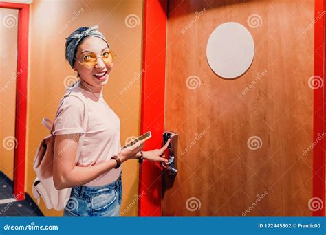 woman entering hotel room  code pad   door stock photo