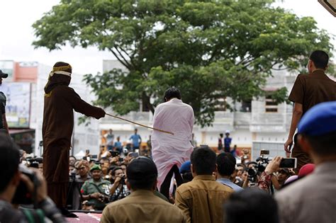 crowds in indonesia watch gay couple publicly caned