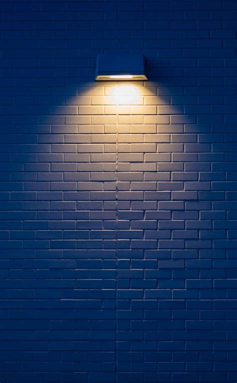 Download 950x1534 wallpaper White wall, yellow lamp, minimal