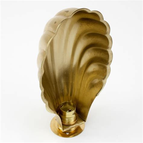 raw brass clam shell shade mm entry  brass wall light raw