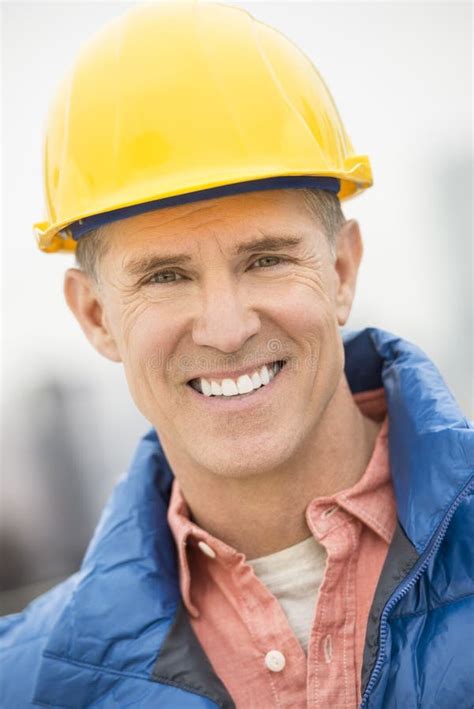 happy construction worker carrying wooden plank stock image image  holding construction