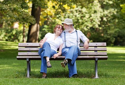 Senior Couple Sitting On A Park Bench Stock Image Image