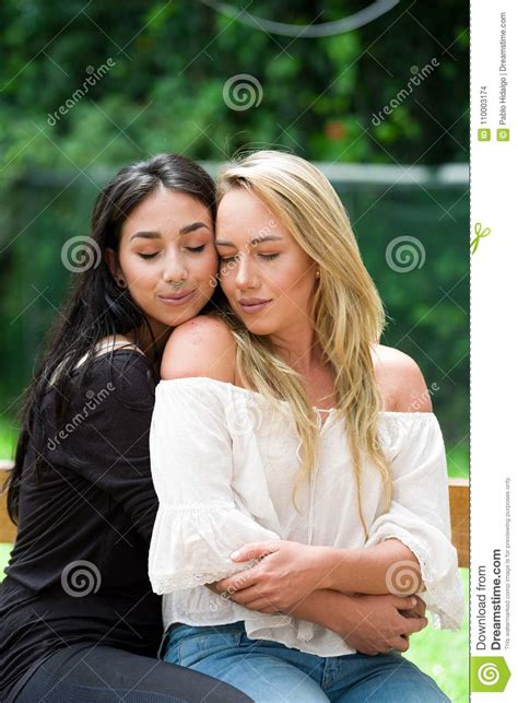 A Pair Of Proud Lesbian In Outdoors Brunette Woman Is Hugging A Blonde