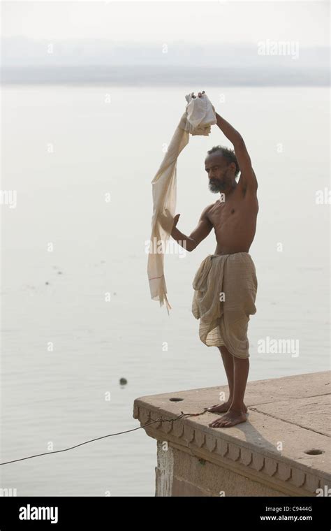 pilgrim airing a dhoti on the ghats lining the river ganges varanasi