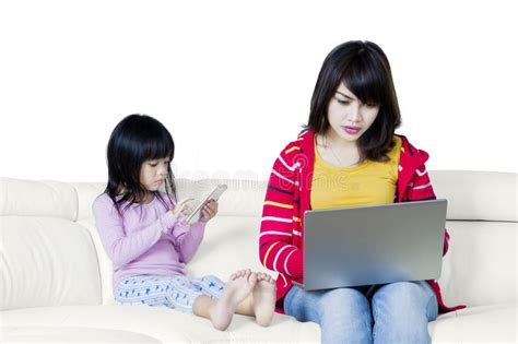 Hispanic Mother And Her Daughter Working On A Computer
