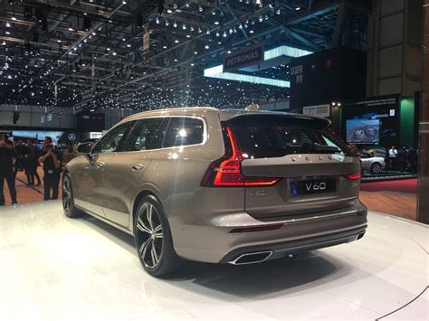 rear    silver volvo car  display   auto show  people standing