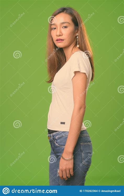 Young Slim Asian Woman Against Green Background Stock