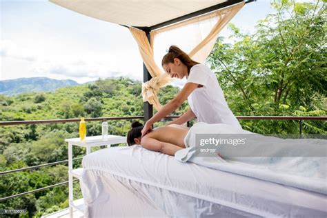 Masseuse Giving Woman A Back Massage At An Outdoors Spa High Res Stock