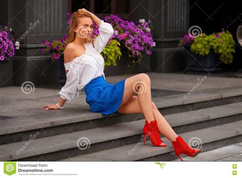 beautiful woman with blue skirt and blond hair posing