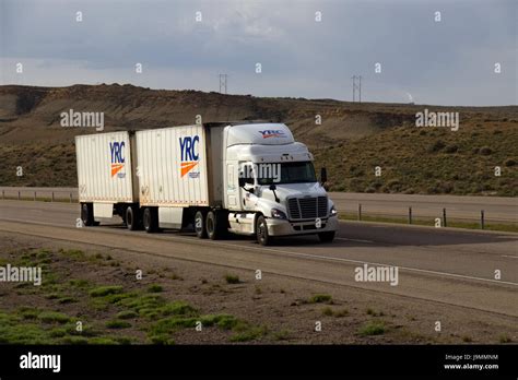 white freightliner semi truck pulling  set  double trailers  stock photo  alamy