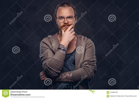 smart pensive redhead hipster with full beard and glasses