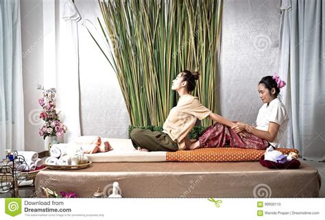 thai masseuse doing massage for woman in spa salon asian