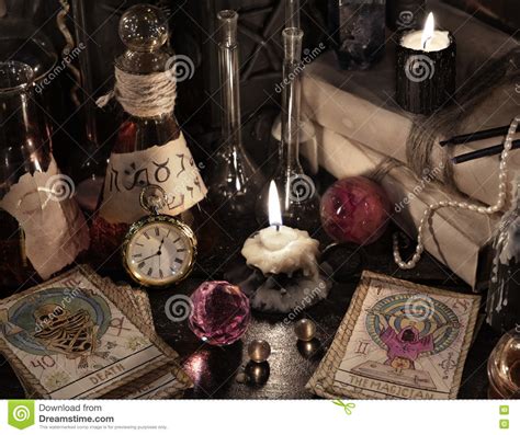 Close Up Of The Tarot Cards Magic Books And Candles Stock