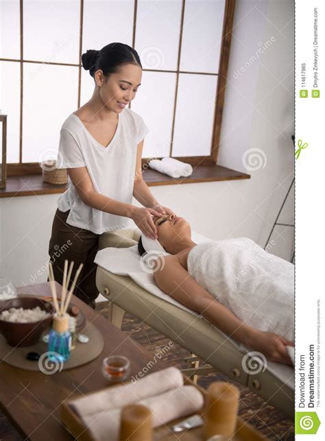 pleasant skillful masseuse working in the spa salon stock image image