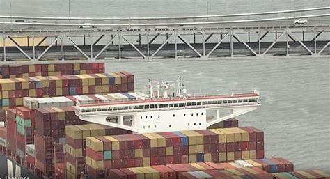 massive freighter  tight fit  bay bridge    port