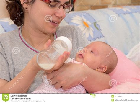 mother feeding  baby stock photo image  baby drinking